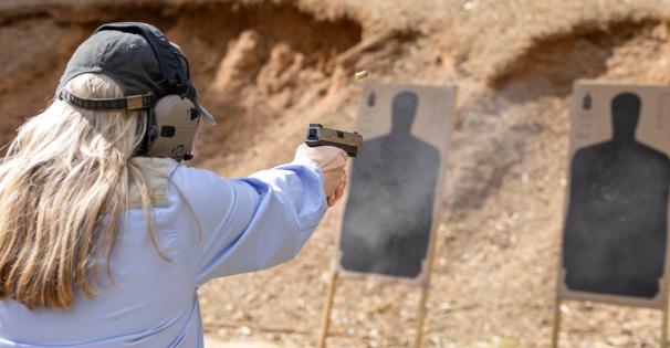 Female shooting a handgun at Turcotte Shooting Facility