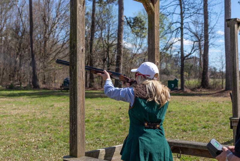 Female shooting shotgun on Turcotte Shooting Facility's Sporting Clay Course